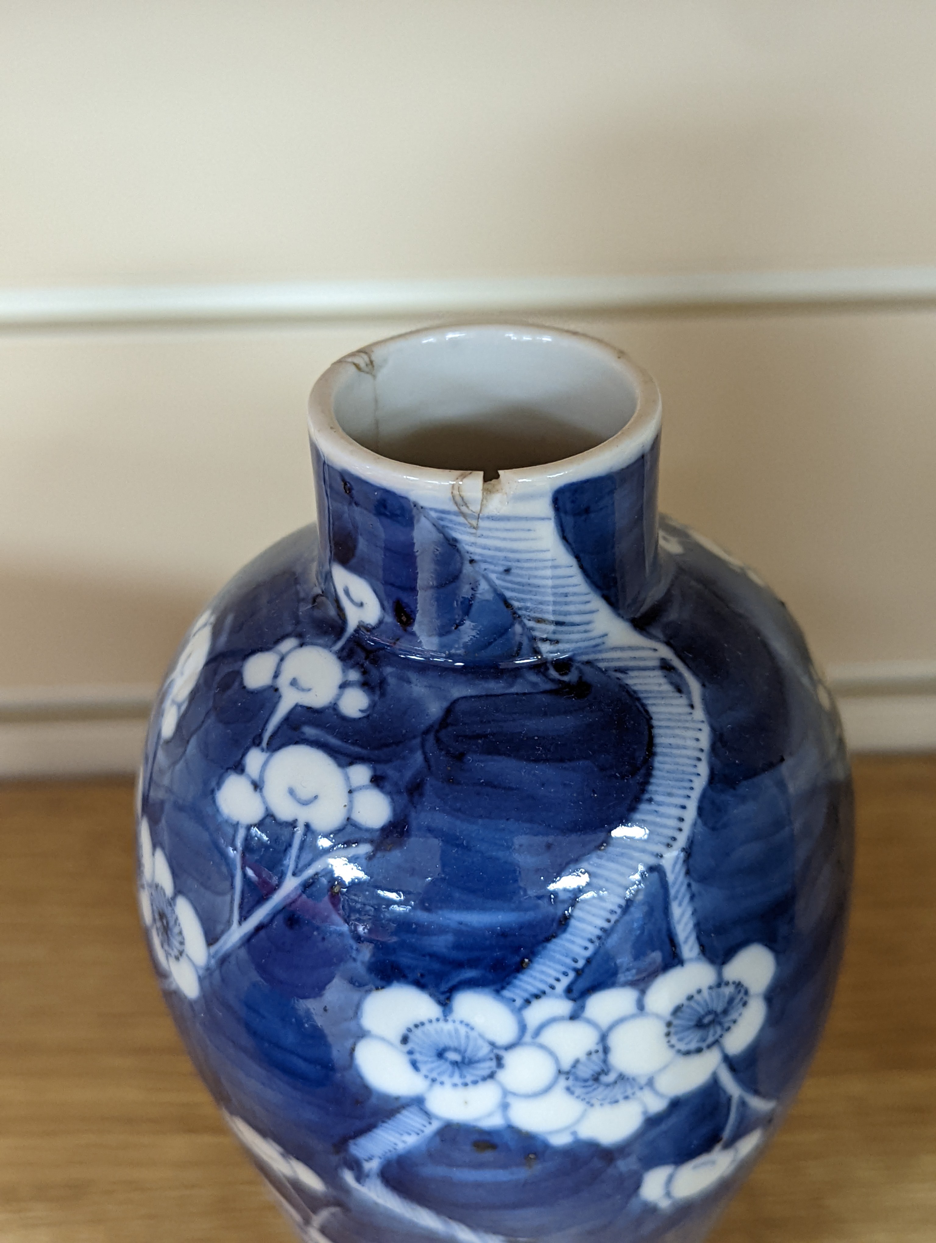 A pair of 19th century Chinese blue and white vases, a prunus vase and cover and a similar jar (4), pair of vases 24 cms high.